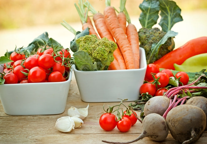 raw foods shown on a table and in two white serving bowls