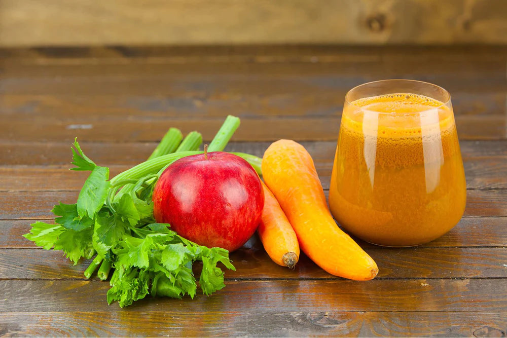 celery apple carrots and a glass of vegetable juice