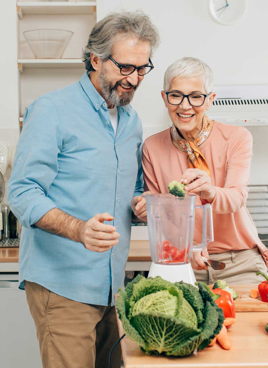 60 Days to Reclaim Your Health - Man and woman in the kitchen blending vegetables