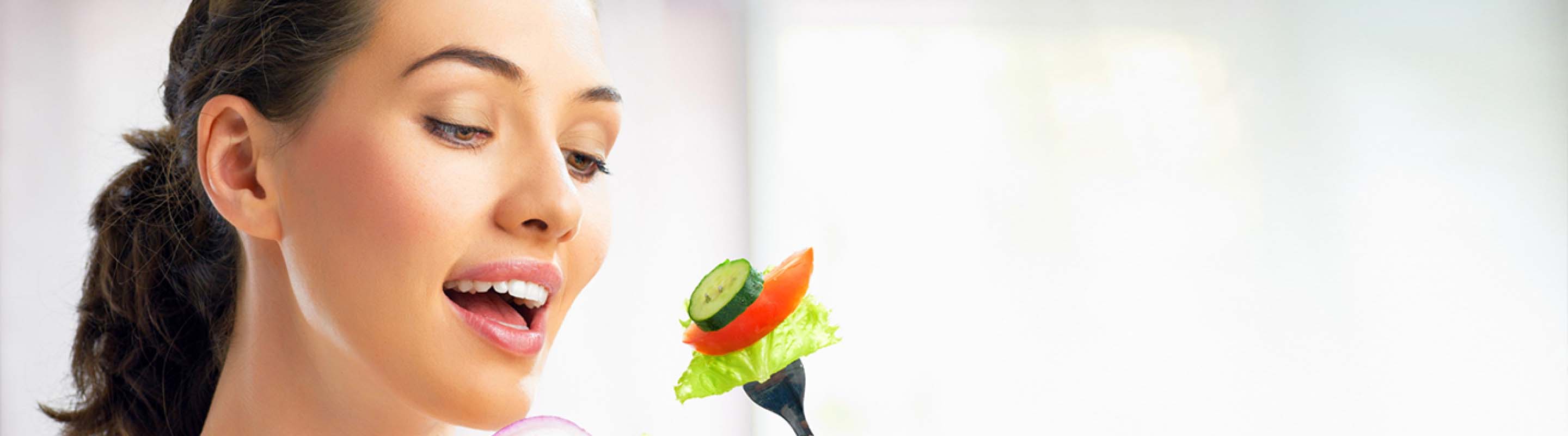 Woman eating vegetables