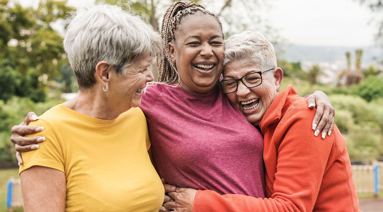 Three women hugging outdoors