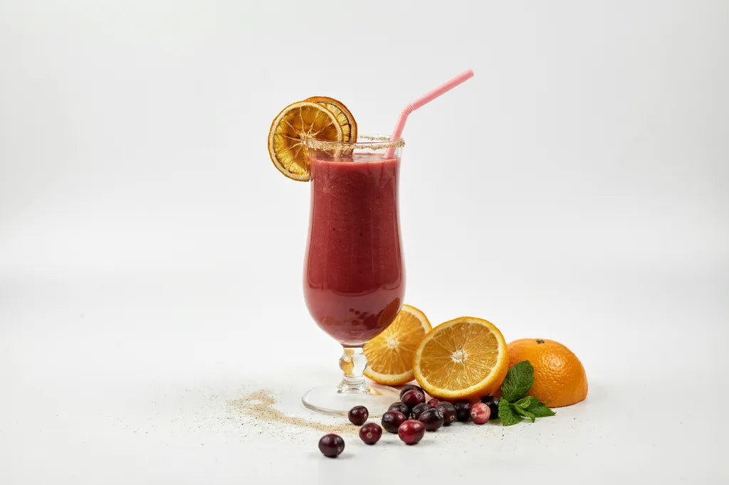 Cranberry Orange Smoothie - a tall glass of deep red smoothie garnished with dried orange slices