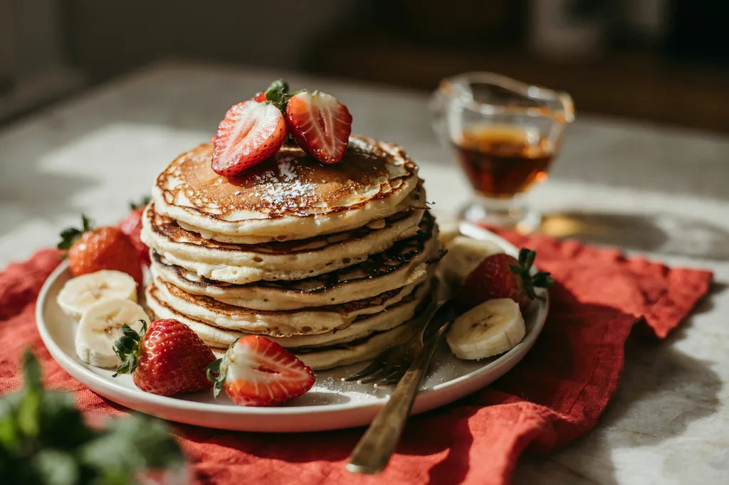 Buckwheat Flapjacks - a stack of golden pancakes topped with strawberries