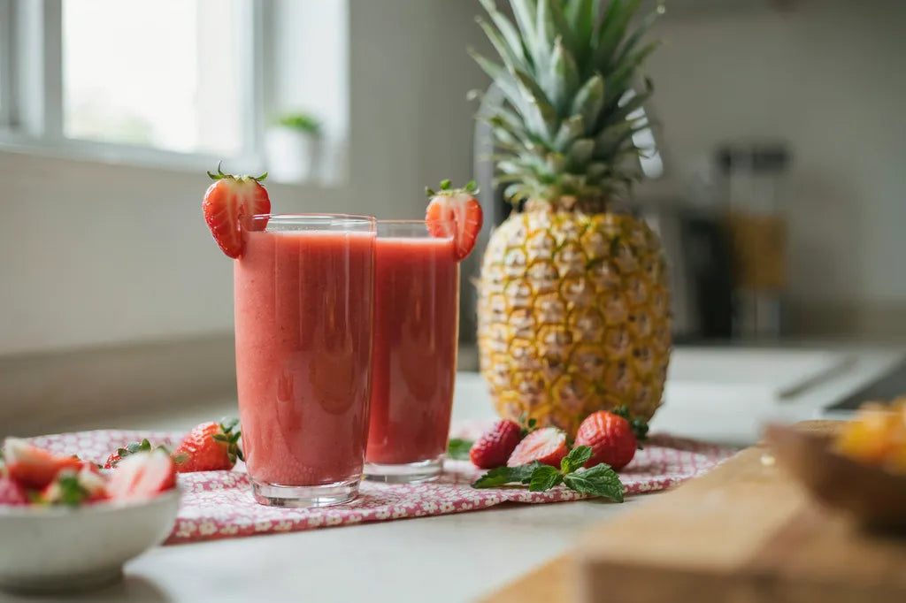 Straw-Apple Smoothie - a pink strawberry smoothie garnished with a fresh strawberry