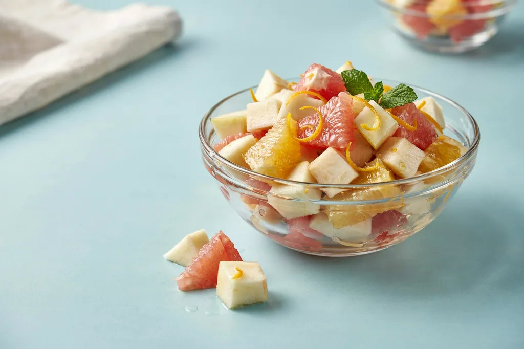 Any Day Fruit Salad - a glass bowl of mixed fruit chunks with citrus dressing