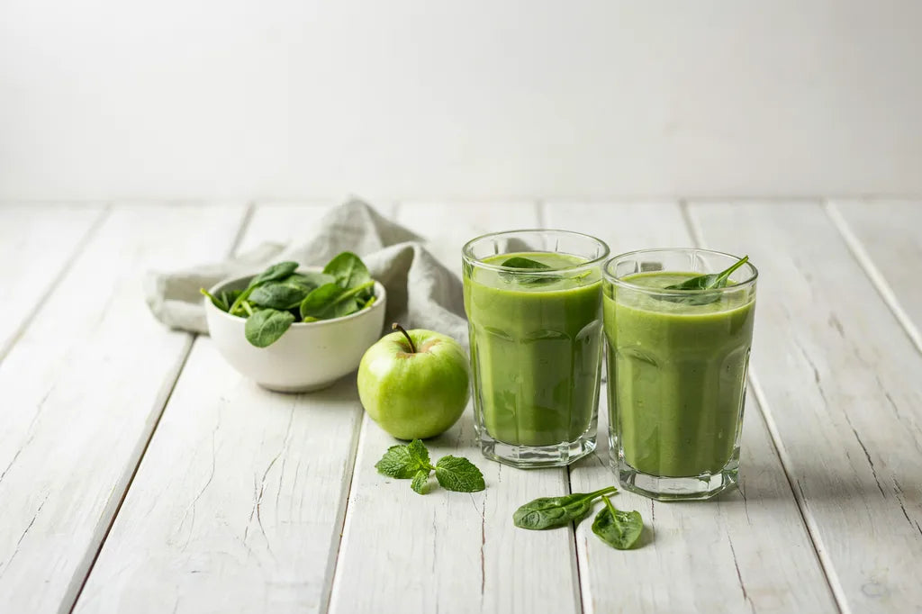 Celery Leaf Smoothie - two glasses of bright green smoothie with fresh spinach