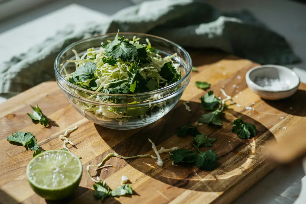 Cilantro Slaw - a glass bowl overflowing with fresh cilantro and shredded cabbage