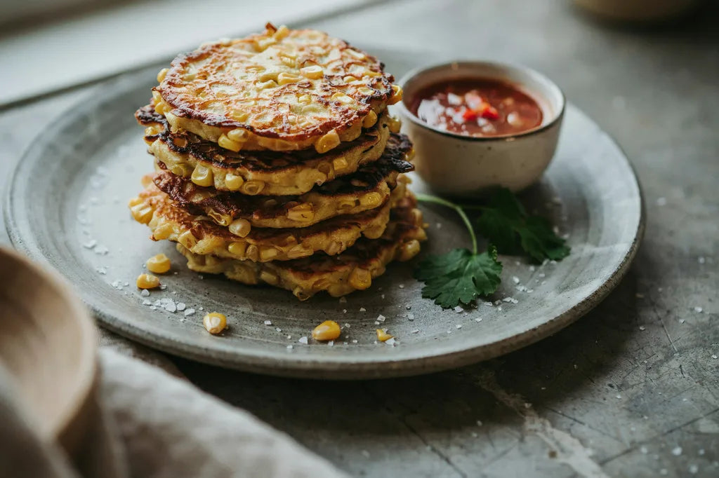Rosemary Corn Fritters - golden corn fritters stacked on a plate