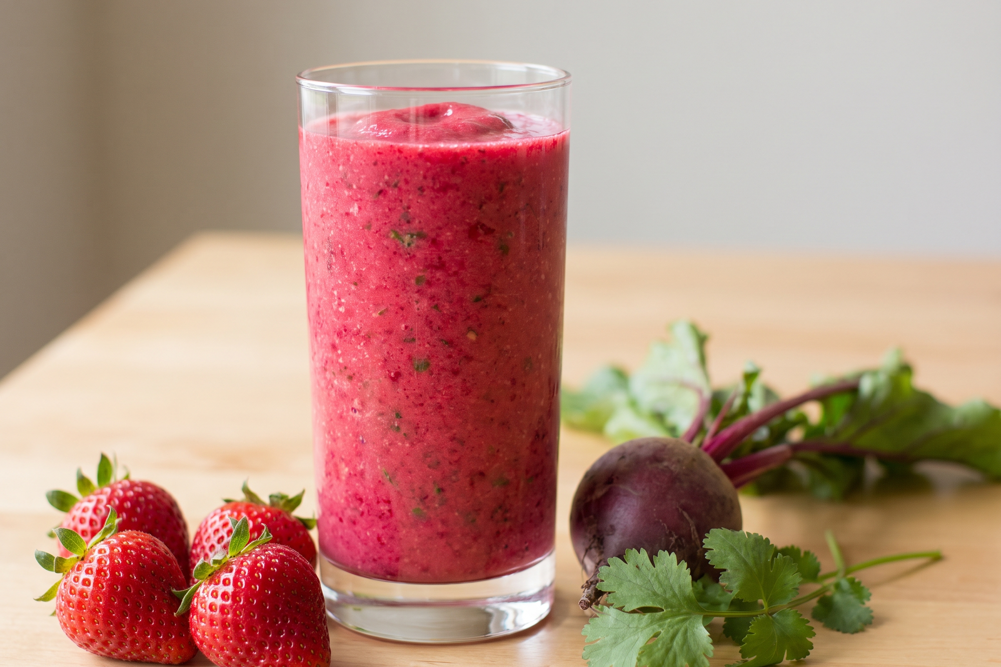 Pink strawberry beet smoothie with fresh strawberries and a beet
