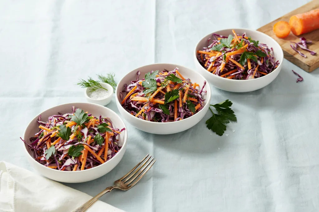 Citrus Vinegar Slaw - white bowls of colorful cabbage and carrot slaw